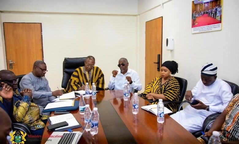 • Mr Apaak (head of table) in a meeting with the committee members