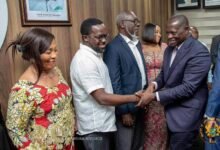 • Mr Buah (right) congratulating a member of the board after the programme