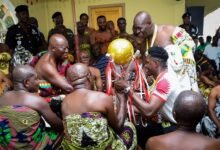 • Goalkeeper Frederick Asare presents the trophy to Otumfuo Osei Tutu II