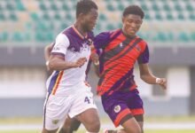 Kojo Gyesi tries to stop an attack from Hearts' Michael Awuah Mensah