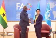 • Mr Eric Opoku (left) and Dr QU Dongyu with the document