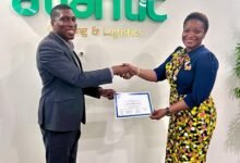 • Mr Lacroix (left) presenting the certificate to Ms Lindsay-Gamrat after the signing