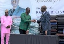 • Mr Morrison (right) presenting the items to Major (Rtd) Kuyon