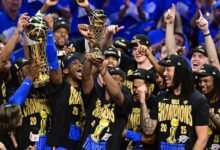 Oklahoma City Thunder players hold the Larry O'Brien Trophy aloft after claiming the NBA title
