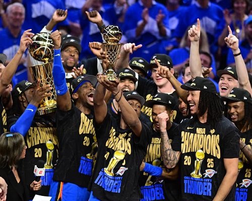 Oklahoma City Thunder players hold the Larry O'Brien Trophy aloft after claiming the NBA title
