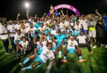 • Players and officials of Police National celebrating with the trophy