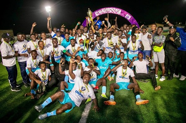 • Players and officials of Police National celebrating with the trophy