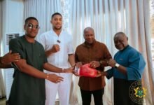 • President John Mahama (second from right) receiving a glove from Anthony Joshua. With them is Azuma Nelson and Sharaf Mahama