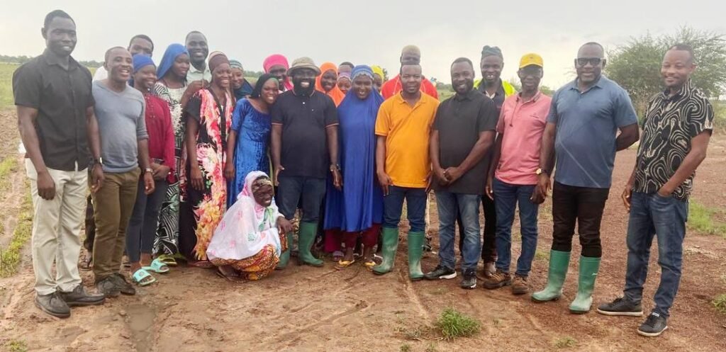 • Dr Peter Boamah Otokunor (middle) with some of the farmers at the farmland