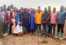 • Dr Peter Boamah Otokunor (middle) with some of the farmers at the farmland
