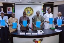 Dr. Joseph Siaw Agyepong (second from left) alongside the Governor of Lagos State and top officials, displaying the signed documents between Zoomlion and Lagos State