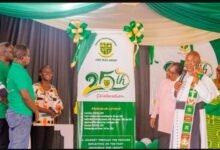 • Father George Amoo (right) launching the anniversary