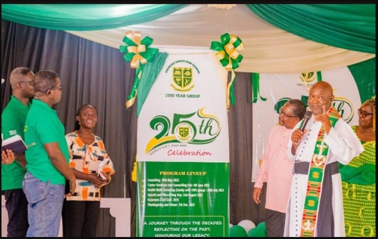 • Father George Amoo (right) launching the anniversary