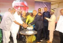 • Nana Konadu Agyeman-Rawlings (middle), Mr Jeffrey Peck (in suit) and other guests cutting the W.E. B. Dubois anniversary cake Photo: Ebo Gorman