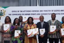 Dr Whittal (second from right) being assisted by other dignitaries to launch action plan book