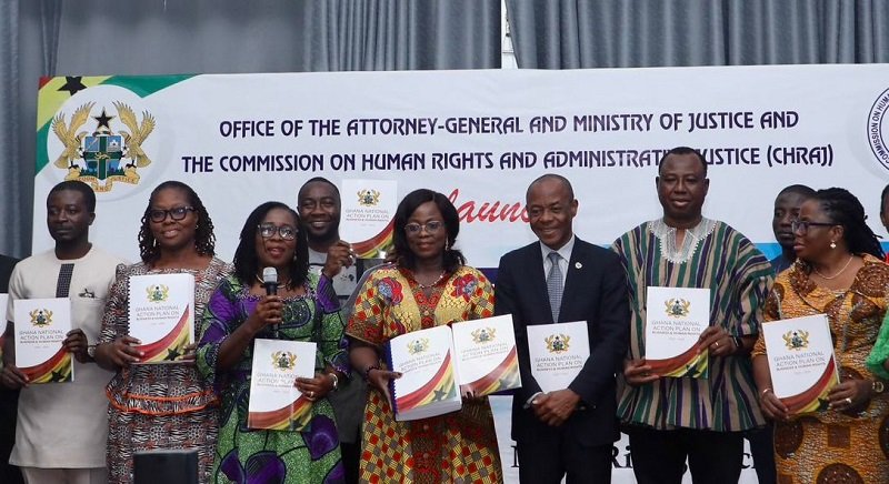 Dr Whittal (second from right) being assisted by other dignitaries to launch action plan book