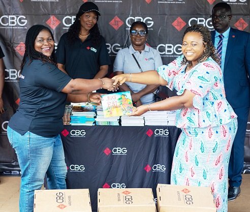 • Dr Kwetey (left) presenting the books to Ms Baidoo