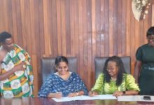 • Prof. Quain and Ms Manikam (middle) signing the agreement