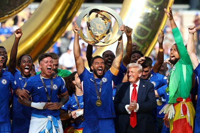 Chelsea's Reece James lifts the trophy as he celebrates with teammates after winning the FIFA Club World Cup, U.S. President Donald Trump looks on