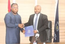 • Mr Divine Selase Agbeti (right) and Mr Dening Edem Hotor showing the document after the signing