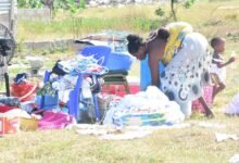 Ms Rachel packing off some of her belongings while her child play innocently around the compound. Photos: Seth Osabukle