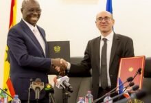 • Dr Forson (left) and Mr Ross exchanging pleasantries after signing the agreement