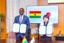 • Mr Haruna Iddrisu, and Toshiko Abe showing the MoU after the signing ceremony