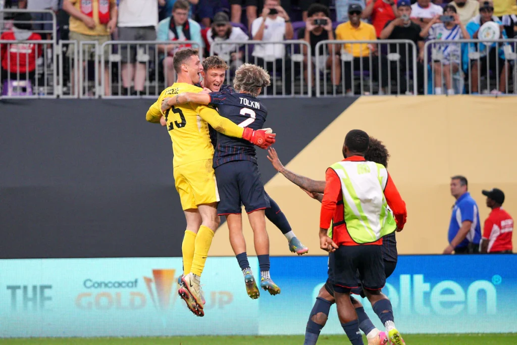 Goalkeeper Matt Freese celebrates with teammates after the victory