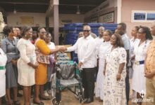 • Mr Francis Asenso-Boakye (right) presenting some of the items to Dr Omari Sasu