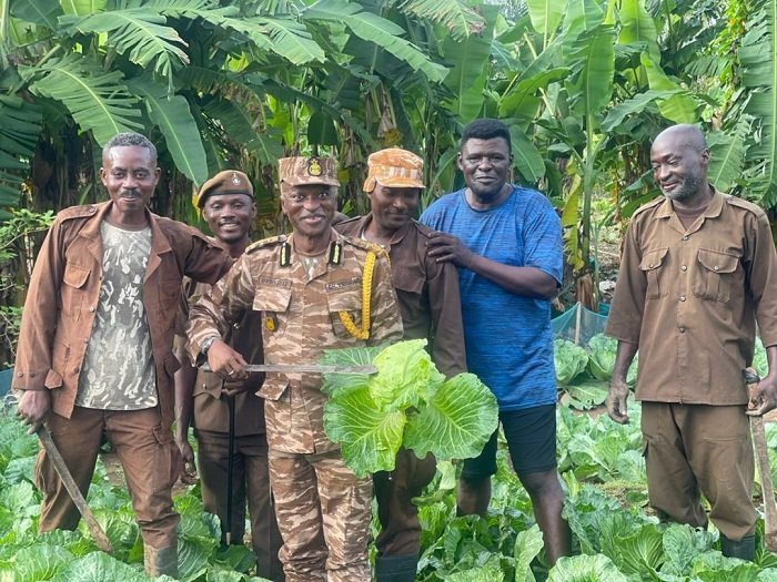 • DDP James Mwinyelle (second from left) with his men on the farm