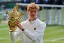 Jannik Sinner celebrates with the trophy