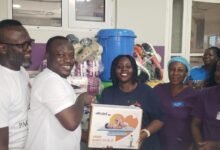 Mr Rexford Jones Bafoe (first left) presenting the items to Ms Elizabeth Koranteng