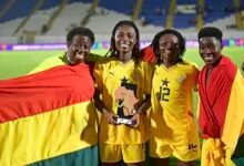 • Kusi flanked by teammates and an official after the win over South Africa