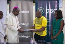 Most Rev Kumordzi (left) and Mr Tetteh exchanging the signed documents