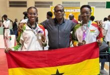 • Mr Lartey Otu with Henrietta (left) and Omolara after their medal presentation