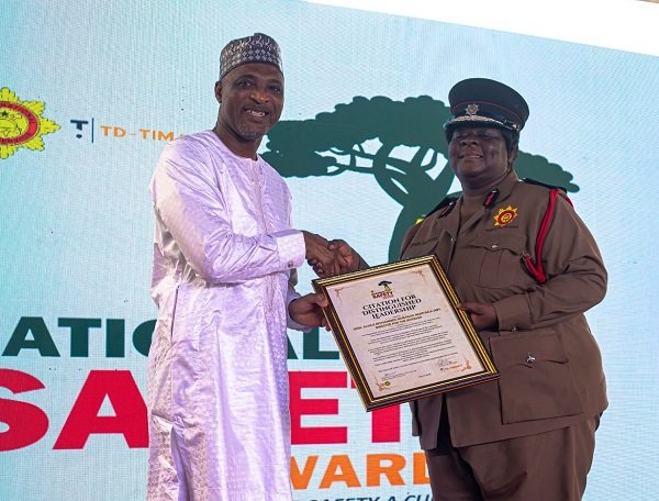 • Mr Mohammed-Mubarak presenting a citation to CFO Sapong