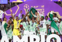 • Rasheedat Ajibade and Veronica Chinwendu joined by other teammates to lift the trophy