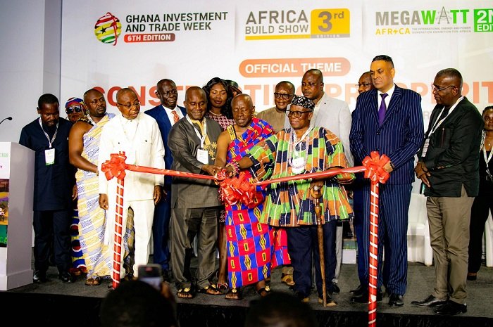 • Ogyeahoho Gyebi II (in kente) being asssited by at the event other dignitaries to open the trade investment week