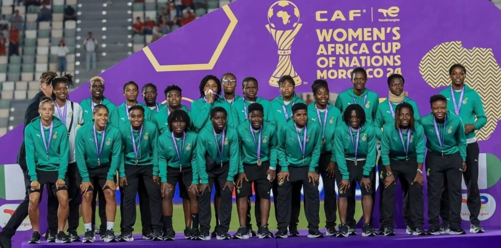 • Players of the Black Queens pose with their medals