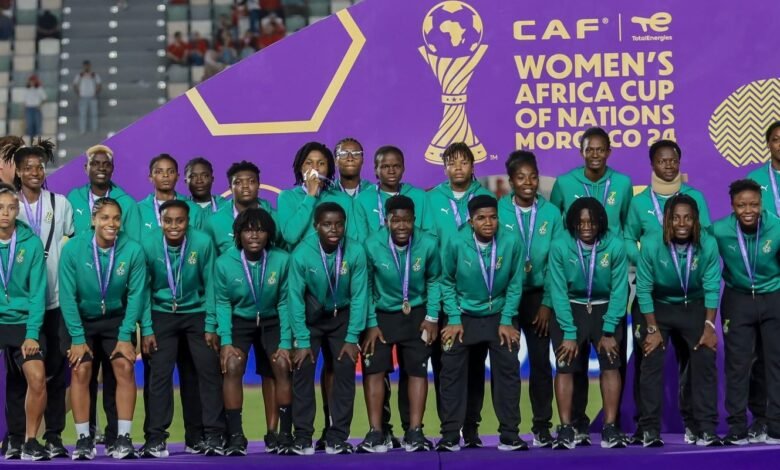 • Players of the Black Queens pose with their medals