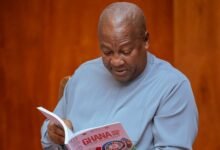 President John Mahama going through some pages at the Voluntary National Review Report