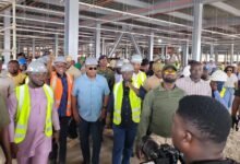 • President Mahama (middle) and other officials inspecting works on the Kejetia market