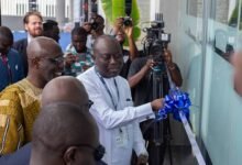 • Mr Ebrima Sillah supported by other dignitaries to cut the tape for the inauguration of the centre