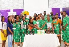 • Mr Rexford Jones Baffoe (middle) and some staff cutting the anniversary cake