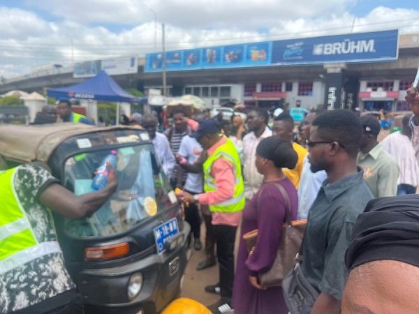 Mr Adam Abubakari Takoro (middle) and other officials monitoring the decongestion exercise