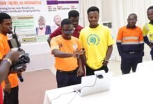 A team showcasing the use of computer technology during the fair