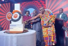 • Vice President Prof. Opoku-Agyemang (left) being assisted by the Chief of Staff, Mr Debrah and Nana Ansah Sasraku III to cut the anniversary cake