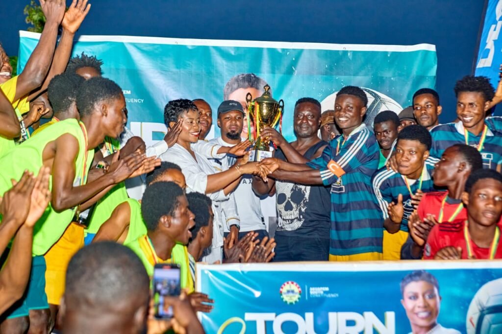 Hon. Dziwornu supported by some former Black Stars players to present the winner's trophy to Banabas FC