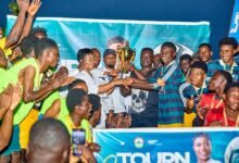 Hon. Dziwornu supported by some former Black Stars players to present the winner's trophy to Banabas FC