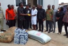 Dr Mensah (third from left) presenting the items to Nii Ampaw